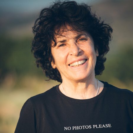 Tzeli Hadjidimitriou was born and raised on the island of Lesvos, Greece, and is an award-winning filmmaker, fine art photographer, and writer. Her photographs, which capture liminal atmospheres, places, and people, have been exhibited in solo and group shows in Australia, China, Italy, Turkey, and Greece and published. After attending a series of seminars by Michelangelo Antonioni on the art of cinematography, she pursued further studies in Cinematography in Rome. Tzeli has been filming and photographing the lives of the inhabitants of Lesvos since 1990. In her work, she uses all her experiences and capacities, aiming to give space and voice to ordinary people, who are not famous or considered extraordinary in any way, but who live their lives in simplicity, outside the daily headlines. Recent films focus on gender, including "Sapphoâ€™s Granddaughters", where the older women of Eressos tell their moving stories; â€˜Mr. Dimitris and Dimitroulaâ€™, a rare record of a gender-nonconforming person on Sykamia Lesvos, who tragically lost his/her life after being unjustly detained in a mental asylum; and â€˜Sappho singingâ€™, a joyful ode to Sappho, who revisits contemporary Lesvos. Her short films have been screened across the world and won several awards. She is an expert on Sappho's poetry and regularly works as a consultant for BBC television on programs about Sappho and Lesvos.